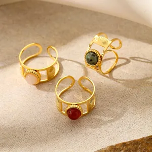 Detail of 18K gold plated stainless steel rings with natural stones and sunray engravings