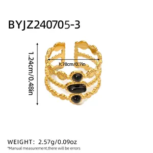 Gold layered hollow ring featuring three oval black natural stones in vintage style