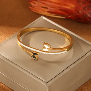 Minimalist gold-plated stainless steel wrap bracelet with black and white butterfly motifs
