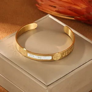 Golden Jesus cuff bracelet with Saint Benedict medals and sparkling zircon insets
