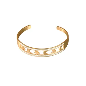 Elegante bracciale rigido in acciaio al titanio dorato con stelle e lune con strass