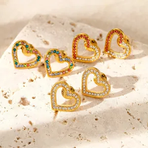 Three pairs of gold heart stud earrings with multicolored rhinestones on stone base