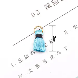 Macro shot of 2cm sky blue fringe tassel with gold metal ring for DIY jewelry making