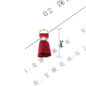 Macro shot of 2cm red fringe tassel with golden metal ring for handmade DIY jewelry