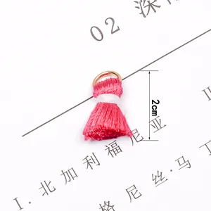 Detailed view of 2cm pink tassel pendant with gold metal ring for DIY jewelry making