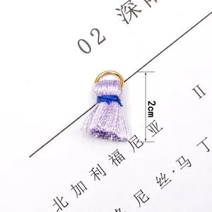 Detail view of 2cm purple mini tassel with blue binding and gold ring connector