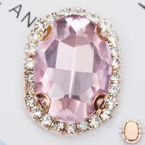 Détail macro d'une pierre en verre rose ovale avec base en cuivre et trous de couture
