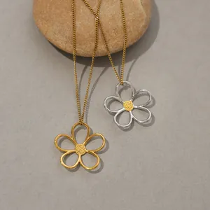 Minimalist stainless steel cutout daisy pendant necklaces on stones in a creative layout