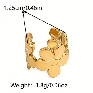 Detail view of golden flower ring showing a width of 1.25cm and weight of 1.8g
