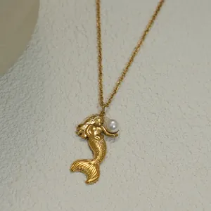 Elegant gold mermaid pendant necklace with freshwater pearl on a minimalist background