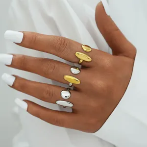Minimalist geometric open rings in gold and silver finish worn on model hand