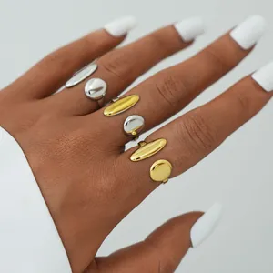 Minimalist polished gold and silver open rings set with reflective geometric discs