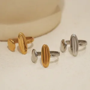 Macro shot of minimalist polished stainless steel rings in gold, silver and bicolor finishes