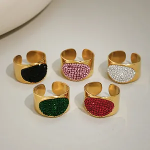 Detailed view of colorful pavé crystals on gold-plated wide oval statement rings