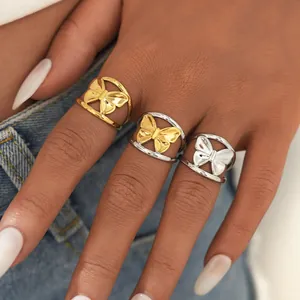 Detailed view of three butterfly bow titanium steel rings in gold and silver finishes