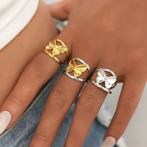 Three-tone bow-shaped titanium steel hollow rings shown on model for a minimalist style