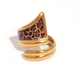 Golden spiral wrap ring with a leopard print triangular panel in a polished finish