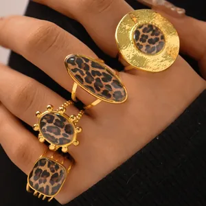 Close-up of four-piece gold ring set featuring geometric shapes and leopard print textures