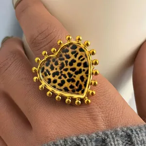 Statement heart shaped leopard print ring with golden beaded edges on model's hand
