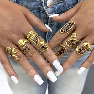 Gold leopard print geometric open rings set worn by model against denim backdrop