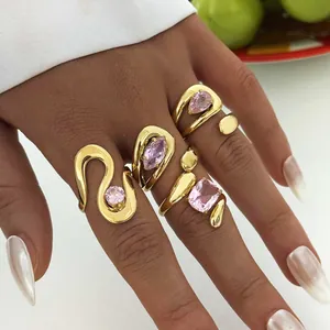 Gold stainless steel droplet zircon ring set featuring geometric pink stones on model's hand