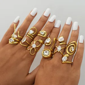 Close-up of vintage gold rings set with zircon stones on model's fingers