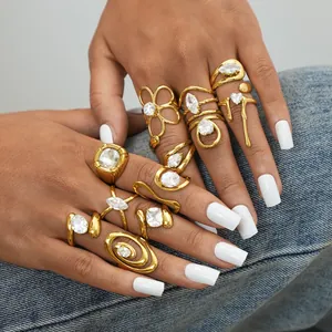 Close-up of vintage gold steel rings set with zircon stones on denim background