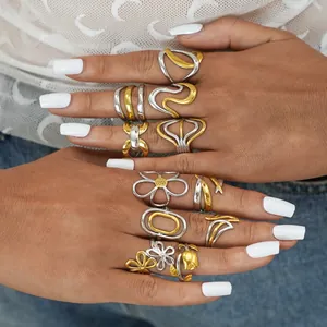 Mixed metal ring set featuring gold and silver floral and wavy geometric designs