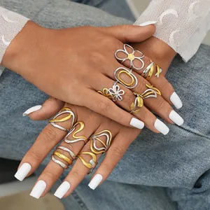 Minimalist irregular layered gold and silver ring set featuring floral and wave patterns