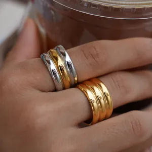 Gepolijste gouden en zilveren brede ringen met golvende textuur voor dames