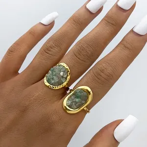 Artistic gold-plated rings featuring natural raw green stones in a bohemian style
