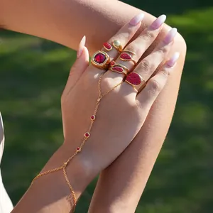 Elegant gold slave bracelet with red crystals and multifaceted gemstones for women