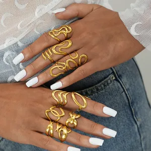 Detailopname van holle goudkleurige ringen op een hand met moderne metalen textuur