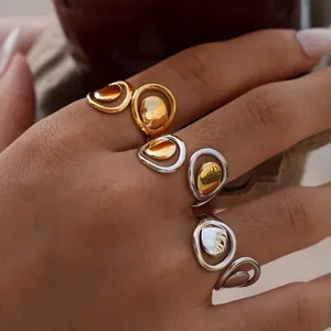 Minimalist geometric hollow open rings with mirror finish spheres in gold and silver