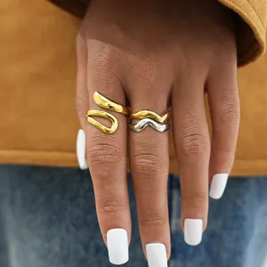 Polished wave style stainless steel open rings in gold and silver finish on finger