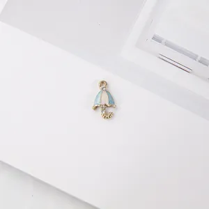Detail view of light blue and white enamel umbrella charm with gold plating and rhinestones