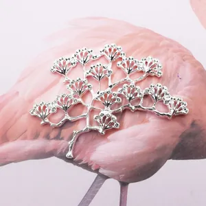 Macro detail of silver branch brooch with sparkling rhinestones on a flamingo gift card