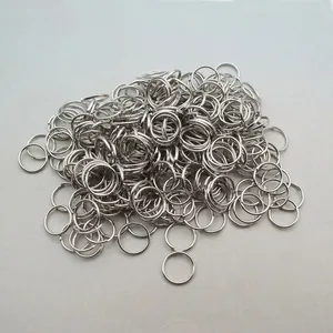 Macro shot of bulk silver metal double-layered open jump rings for DIY jewelry crafting