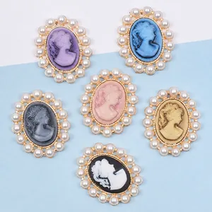 Detail of vintage oval cameo charms with faux pearls for DIY bridal hair accessories