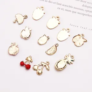 Assorted gold alloy fruit charms for DIY jewelry making including cherry and pineapple