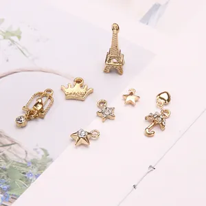 Golden alloy DIY charms set featuring Eiffel Tower, crown, star and heart pendants