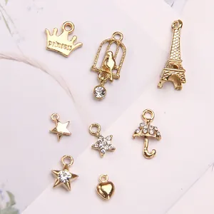 Golden alloy DIY jewelry pendants including crown, Eiffel Tower, stars, and heart shapes