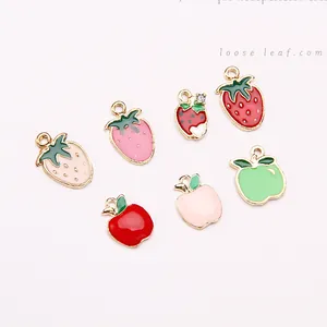 Close-up of alloy enamel fruit charms including strawberry and apple for DIY jewelry
