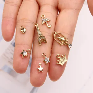 Golden alloy charms set including Eiffel Tower and heart shapes for DIY jewelry making