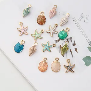 Detailed flat lay of sea star and shell alloy pendants for DIY jewelry crafting