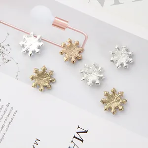 Detail view of 6 pieces sparkling snowflake rhinestone charms in gold and silver metal finish