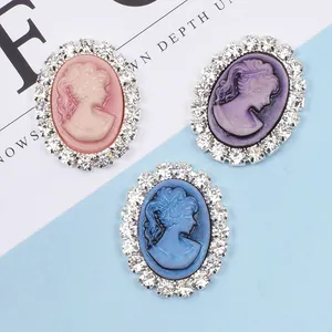 Oval cameo charms with crystal borders in pink, purple, and blue for DIY hair accessories