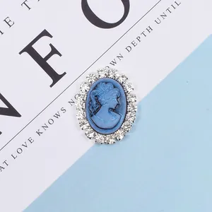 Detailed macro view of vintage blue oval cameo with silver base and rhinestone border