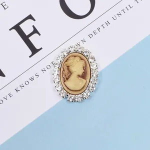 Detailed macro view of oval vintage cameo pendant with clear rhinestone border trim