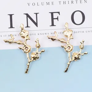 Golden branch branch stud earrings with elegant white pearls and floral metal accents